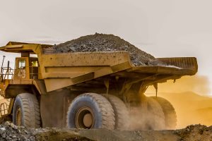 A large truck carrying sand on a mining site 